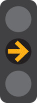 A 3 light traffic signal with the middle yellow arrow light on.