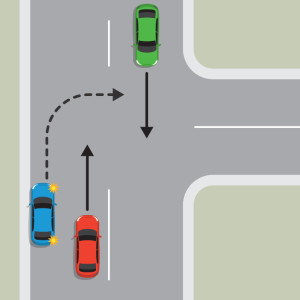 The blue car is pulled over to the left-hand side of the road to wait for the red car and green car to pass and the road to be clear before turning right