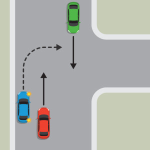 The blue car is pulled over to the left-hand side of the road to wait for the red car and green car to pass and the road to be  clear before turning right