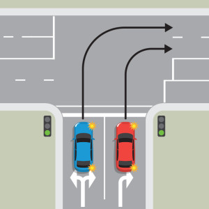 A blue car and a red car are waiting to turn right from a one-way street. The blue car in the left lane must stay in the left lane through the intersection. The red car in the right lane must stay in the right lane through the intersection.