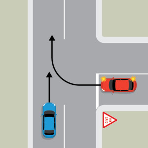 A blue car is driving straight on the continuing road of a T intersection. A red car is at the top of the terminating road on the right, indicating to turn right into the flow of traffic. The red car is behind a give way sign and white line.
