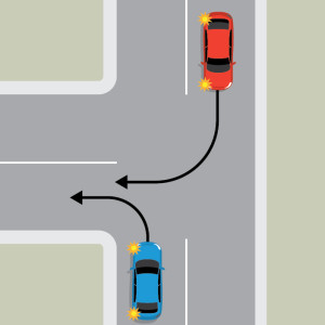 A blue car is indicating to turn left at a T intersection. An oncoming red car is indicating to turn right into the same lane.