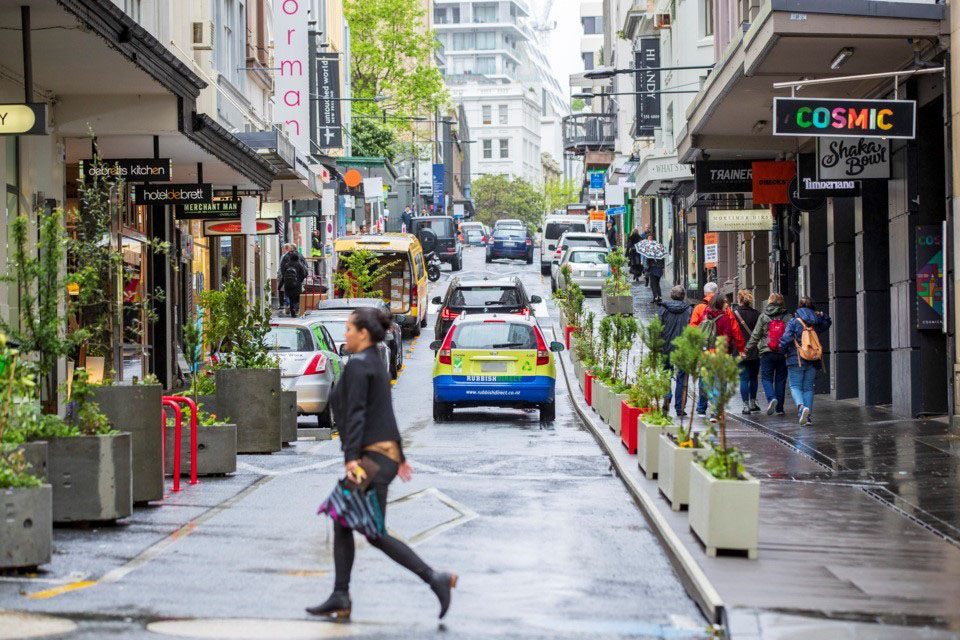 Woman walking across a one-way street in Central Auckland.