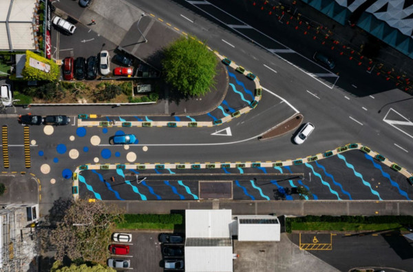 A birds eye view of a road with painted markings on either side to narrow traffic lanes 