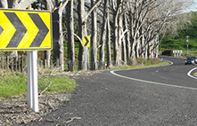 yellow direction chevron signs line up a road