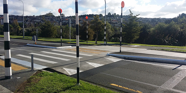 A pedestrian crossing where the crossing is raised slightly above the level on the road