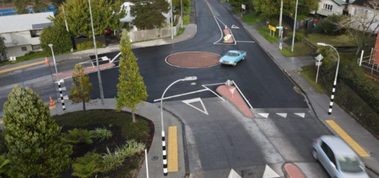 Photo of car driving around a new roundabout that replaced a previous t-intersection