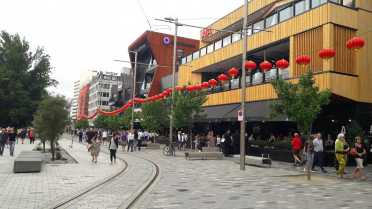 Hanging Chinese lanterns line the pedestrian walkway and tram railway in Christchurch