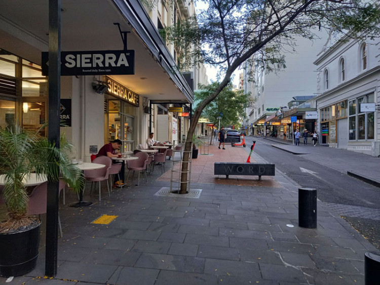 Street showing no proper alignment of features with the arrangement of tree  and bench obstructing the path