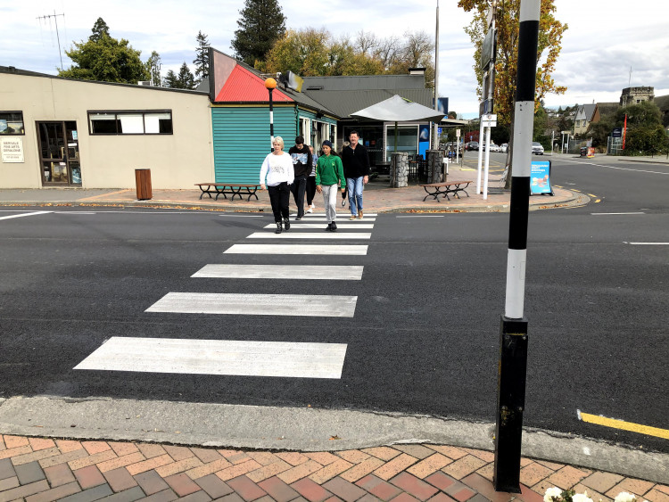 a photo showing a flush or road level zebra crossing