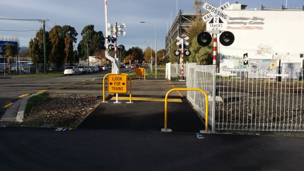 a photo showing a pedestrian level crossing of a railway