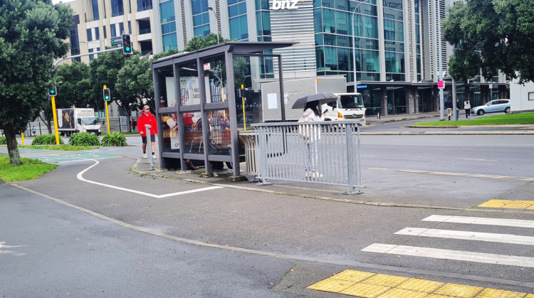 Bus stop with steel fencing next to it