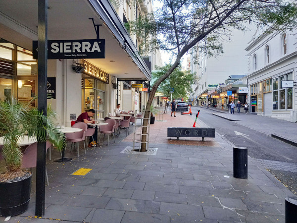 Outdoor dining that has been fenced off from accessible zone 
