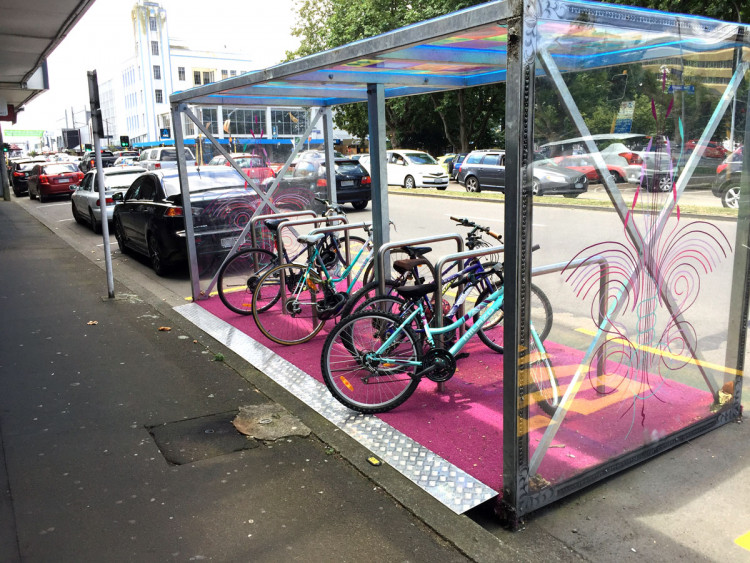 Moveable bicycle parking shed in a car park space.