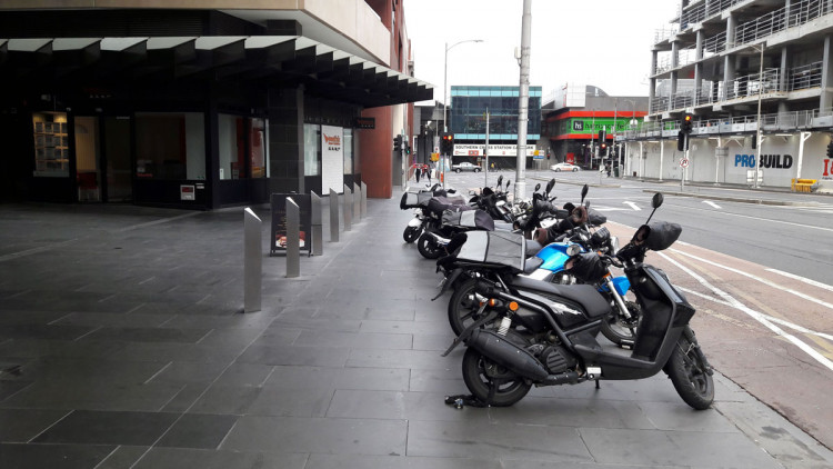 Motorcycle parking on the footpath reducing the footpath width