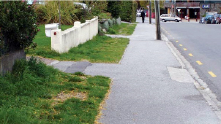 driveway with normal pedestrian path crossfall maintained and a steep vehicle crossing