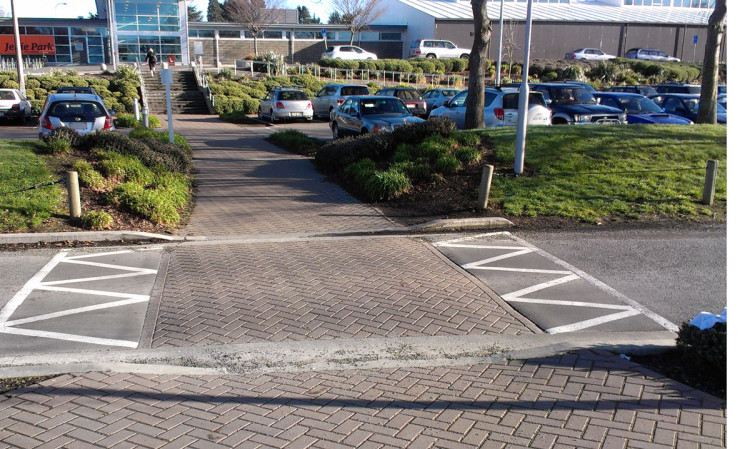 Direct path from car park to main entrance, prioritizing pedestrian flow.