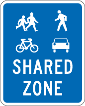 A blue sign with white SHARED ZONE text 