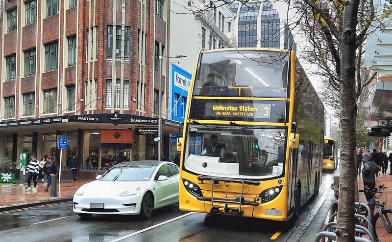 A yellow double desk bus on the road