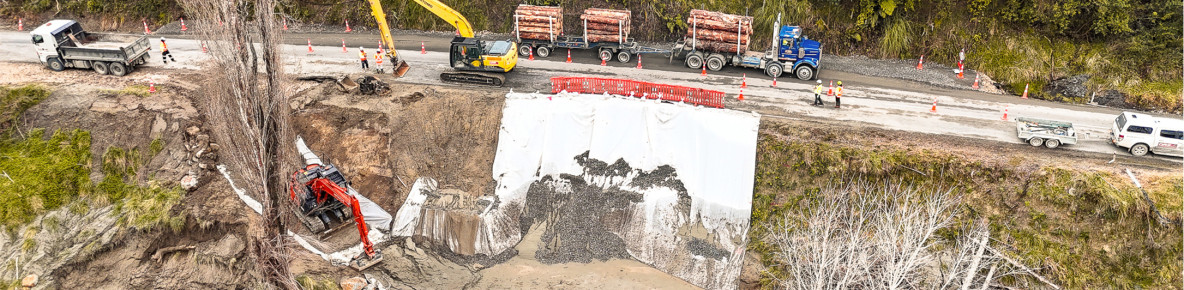 Construction vehicles and crew working on a site to repair an underslip