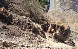 The Abseil Access crew works to clear a 50 tonne boulder at Slip 14