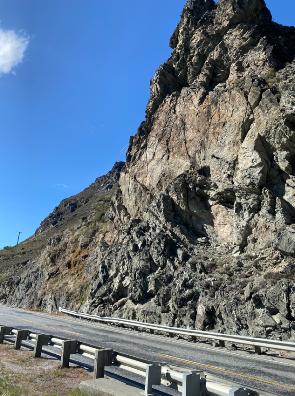 Rock face towering over road