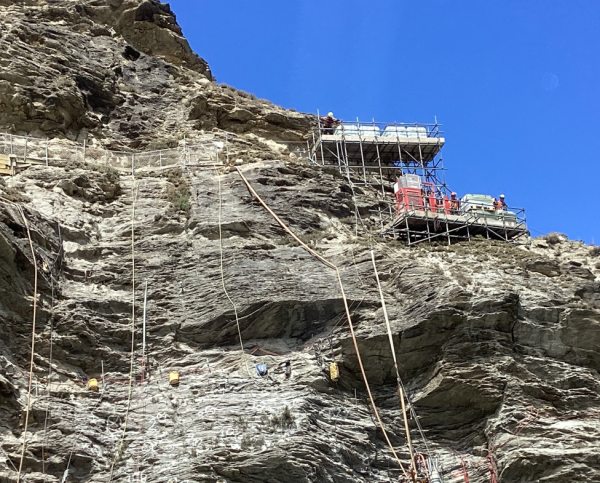 Scaffolding and ropes on the cliff face.