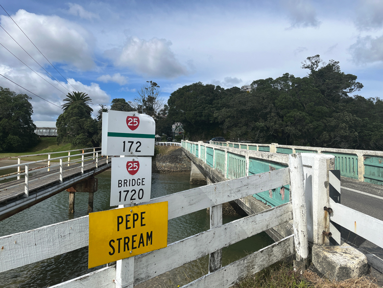 A stream bridge with a sign displaying the words Pepe Stream.