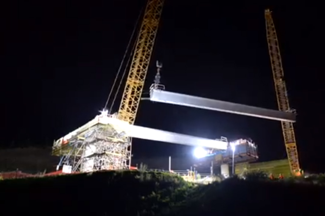 Installing bridge beams at night.